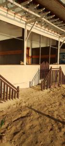 a group of chairs sitting in front of a building at ALFA Beach Front Lodge in El Nido