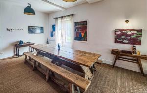 a large wooden table in a room with a window at Lovely Home In Laurens in Laurens