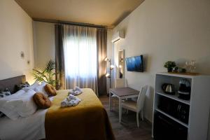 Postel nebo postele na pokoji v ubytování Verona Suites and Rooms