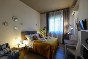 Postel nebo postele na pokoji v ubytování Verona Suites and Rooms