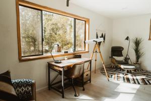 a home office with a desk and a window at Lovers nest by Casa Oso with private hiking trails and pond in Mariposa