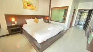 A bed or beds in a room at SM Patong Resort