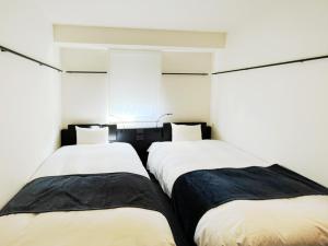 Postel nebo postele na pokoji v ubytování HOTEL SUI KANDA by ABEST