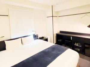 Postel nebo postele na pokoji v ubytování HOTEL SUI KANDA by ABEST