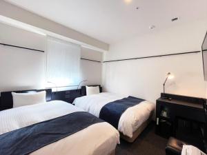 Postel nebo postele na pokoji v ubytování HOTEL SUI KANDA by ABEST