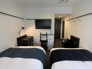 Postel nebo postele na pokoji v ubytování HOTEL SUI KANDA by ABEST