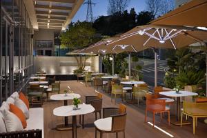a restaurant with tables and chairs and umbrellas at Home2 Suites by Hilton Guiyang Airport in Guiyang