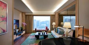 a living room with a couch and a large window at Galaxy Macau in Macau
