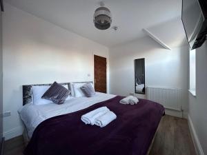a bedroom with a large bed with towels on it at Brooklands Filey Seaside Retreat Flat 6 in Filey