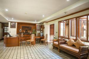 a living room with a couch and a kitchen with a table at Jirung Health Village in Mae Rim