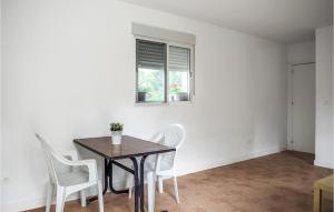 a dining room with a table and white chairs at 1 Bedroom Nice Home In Xativa in Xàtiva