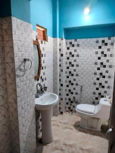 a bathroom with a white sink and a toilet at Namaste Caffe-for heritage stay in Jodhpur