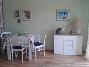a dining room with a white table and chairs at Apartment Splitska in Splitska