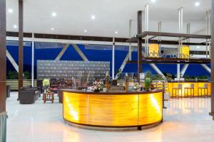 a lobby with a bar in the middle of a building at Palace Hotel in Puncak