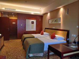 Ένα ή περισσότερα κρεβάτια σε δωμάτιο στο Empark Grand Hotel Kunming