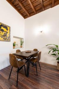 a dining room with a wooden table and chairs at Appartamento trastevere Roma in Rome +25 photos
