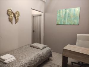 a bedroom with a bed and a butterfly decoration on the wall at Love Truth Life in Piraeus