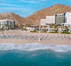 an aerial view of a beach with chairs and umbrellas at Address Beach Resort Fujairah Apartment 2 Bed Rooms and Small Bed Room - Ground Floor 3011 in Al Aqah