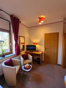 a living room with a couch and a table at Hotel Brauhaus Wittenberg in Lutherstadt Wittenberg