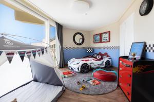 a childs bedroom with a car bed and a desk at Kensington Resort Seorak Beach in Sokcho