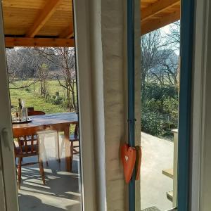 a view from the door of a patio with a table at Holiday Home Paunovaca in Erdut