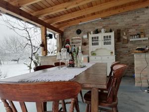 a kitchen with a table and chairs in a room at Holiday Home Paunovaca in Erdut