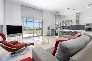 Il comprend un grand salon avec un canapé et une télévision. dans l'établissement luxury sea view apartment with 2 rooms, à Valence