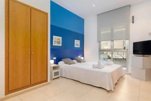 - une chambre avec un grand lit et un mur bleu dans l'établissement luxury sea view apartment with 2 rooms, à Valence