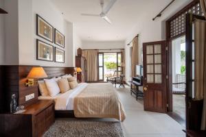 a bedroom with a large bed and a balcony at 42 Lighthouse Street in Galle