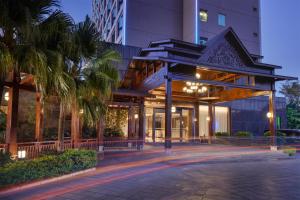 a building with a gazebo in front of a building at Empark Grand Hotel Kunming in Kunming