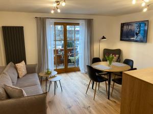 a living room with a couch and a table at Ferienwohnung Einklang in Krün +32 photos