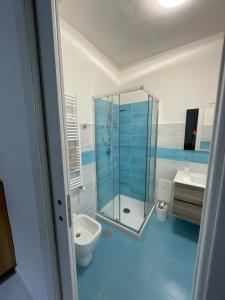 a bathroom with a shower and a toilet and a sink at Merola Sisters Holiday Home in Caserta