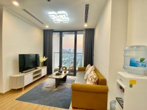 a living room with a couch and a television at Vinhomes Skylake Hanoi - CitiHome in Hanoi