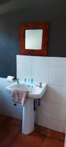 a bathroom with a white sink and a mirror at Woodpecker on Marine in Margate