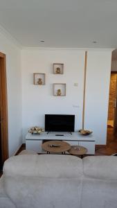Televízia a/alebo spoločenská miestnosť v ubytovaní Loft Turístico