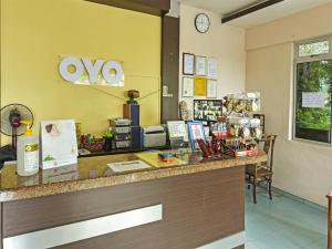 a store counter with aoya sign on the wall at Super OYO 44036 Hotel De Perdana Hill in Batu Pahat