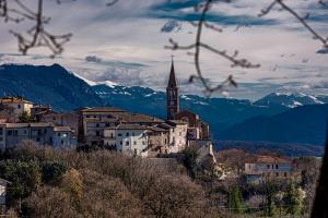 een stad met een kerk en bergen op de achtergrond bij Casa Verdi Colli in Montecastrilli