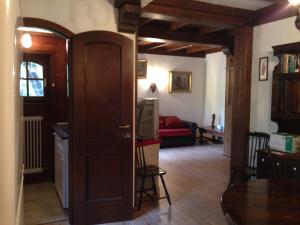 a room with a door and a living room with a couch at Appartamento Scoiattolo in Folgaria