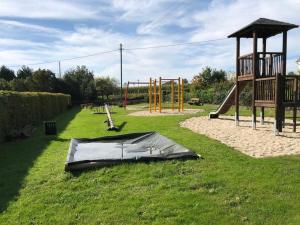 a playground with a tarp on the grass at Alte Schule Seinsfeld in Seinsfeld