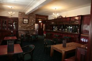 a restaurant with tables and chairs and a bar at The Plough Inn in Pocklington