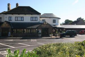a car parked in a parking lot in front of a building at The Plough Inn in Pocklington