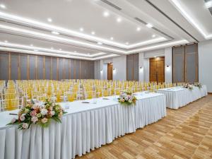 a row of tables in a large room with chairs at Ana Mandara Cam Ranh in Cam Ranh +168 photos