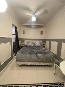 a bedroom with a bed and a ceiling at Chambre de luxe 95 Grise in Deuil-la-Barre