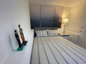 a bedroom with a bed with a skateboard on it at Stylish flat next to Tower of London and SKD marina in London