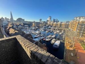 a group of boats docked in a harbor at Stylish flat next to Tower of London and SKD marina in London