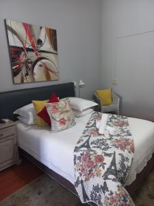 a bedroom with a bed with a blanket on it at Dreamers Guesthouse - NO LOADSHEDDING in King Williamʼs Town