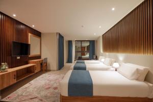 Voodi või voodid majutusasutuse Pyramid Front Hotel toas