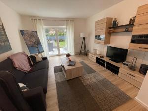 a living room with a couch and a tv at Ferienwohnung Fenke in Fenke