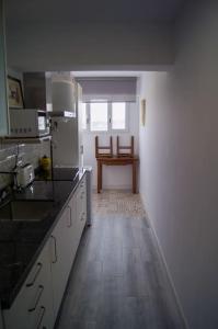 a kitchen with a wooden floor and a table in it at ROCH - Stylish Apartment near Metro in Seville