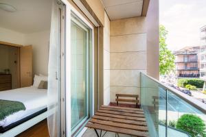 a room with a balcony with a bed and a window at Il Parco 7 by Quokka 360 - in the business centre of Lugano in Lugano